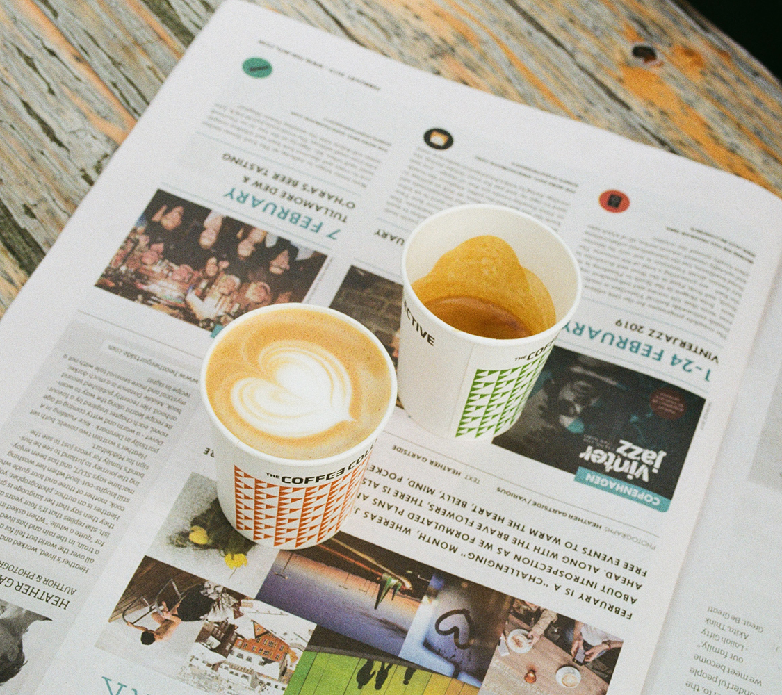 Photo of two cappuccinos on a newspaper